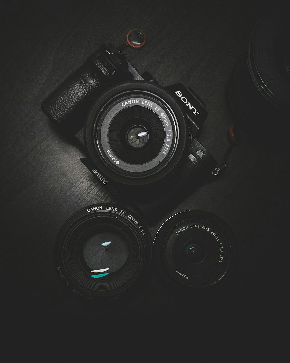 Camera lenses on a desk for photo compression workflows